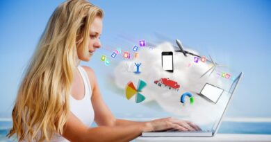 pretty blonde using her laptop at the beach against cloud computing graphic with apps